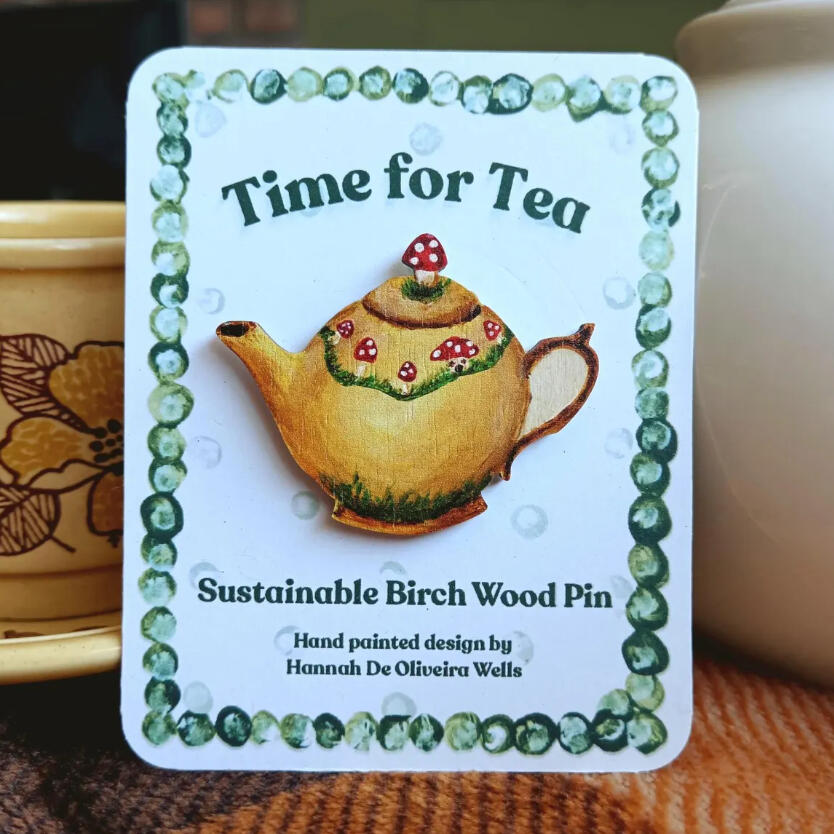 A toadstool teapot illustration now available as a sustainable birch wood pin.