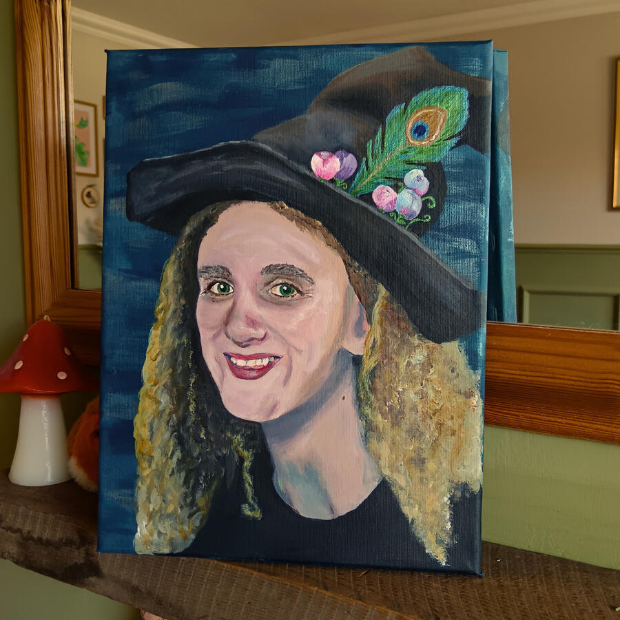 A portrait of a beautiful woman wearing a witch&#39;s hat painted in acrylics on stretched canvas.